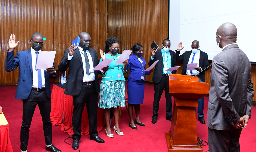 Staff of the Department of Communication and Public Affairs taking oath. Looking on is the Deputy Clerk Parliamentary Affairs, Paul G. Wabwire, who administered the Official Oath and Oath of Secrecy.